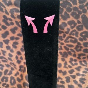 Pink arrow shaped earrings.